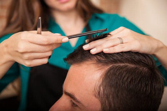 Closeup of a woman cutting hair
