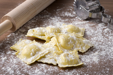 homemade uncooked ravioli with a roller