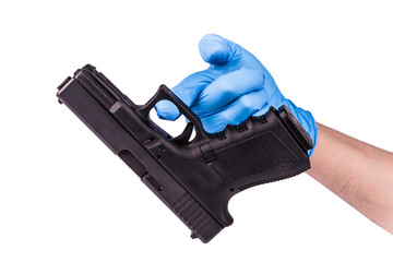 Hand in blue latex glove keeps handgun as evidence