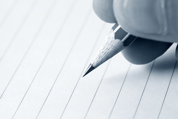 Male hand writing in notebook