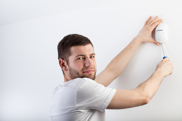 Man installing a security system