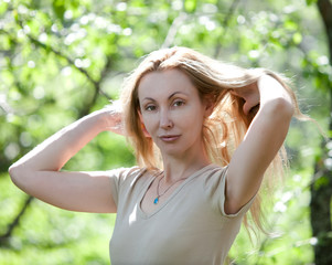 summer portrait of the young attractive woman