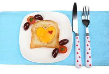 Scrambled eggs with bread on plate, on color napkin