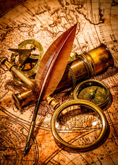 Vintage magnifying glass lies on an ancient world map