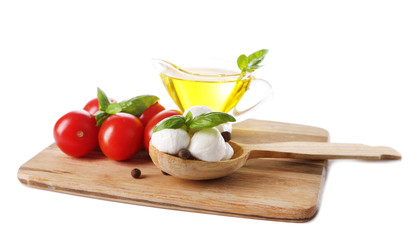Composition with tasty mozzarella cheese balls, basil and red © Africa Studio
