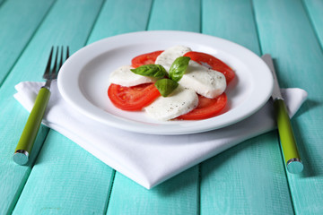 Caprese salad with mozarella cheese, tomatoes and basil