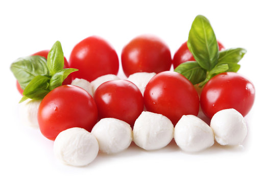 Tasty mozzarella cheese balls with basil and red tomatoes,