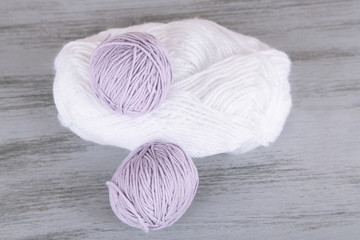 Balls of wool on wooden table background