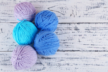 Balls of wool on wooden table background