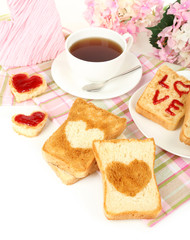 Delicious toast with jam and cup of tea on table close-up