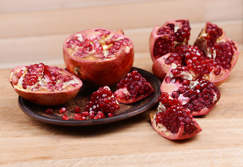 Ripe pomegranates on table close-up