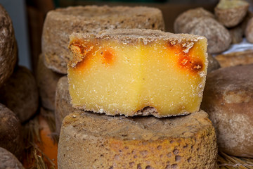 Hard mature cheese on the stand.