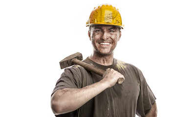 Young dirty Worker Man With Hard Hat helmet  .holding a hammer - obrazy, fototapety, plakaty