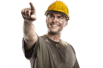 pointing young dirty Worker Man With Hard Hat helmet - obrazy, fototapety, plakaty
