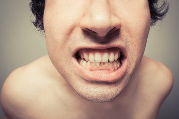 Young man with plaque on his teeth