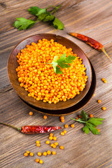 .Red lentils pepper and parsley wooden plate