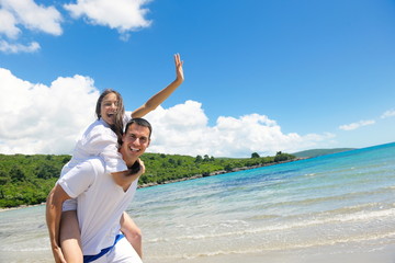 happy couple have fun on the beach