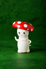 cute puppets handmade, one mushrooms, green background