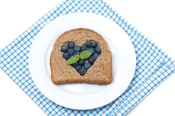 a piece of bread with the middle filled with blueberries