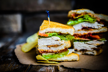 Club sandwich on rustic wooden background