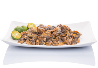 Fresh boiled cockle meat with calamansi fruit in a white plate
