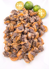 Fresh boiled cockle meat with calamansi fruit in a white plate