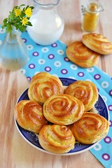 Pastry rolls with custard on wooden background