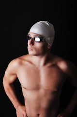 Male swimmer isolated on black