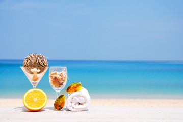 Orange,sunglass and hand towel on the beach