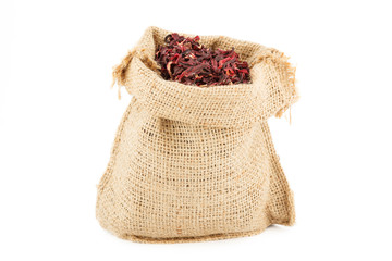A linen sack is filled by the leaves of tea