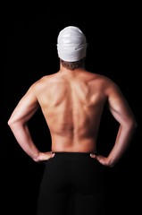 Fototapeta na wymiar Male swimmer isolated on black