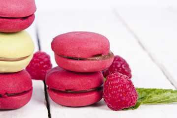macaroons stacked on white wooden background, cupcakes