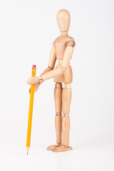 Small wood mannequin stand writing with colour pencil isolated o