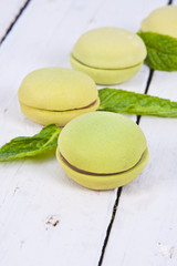 macaroons stacked on white wooden background, cupcakes