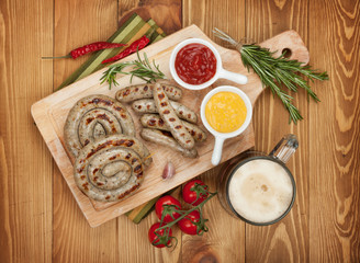 Grilled sausages with ketchup, mustard and mug of beer