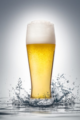 Glass of beer with water splash. 