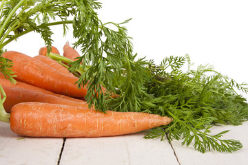 stacked fresh carrots on white background, vegetables