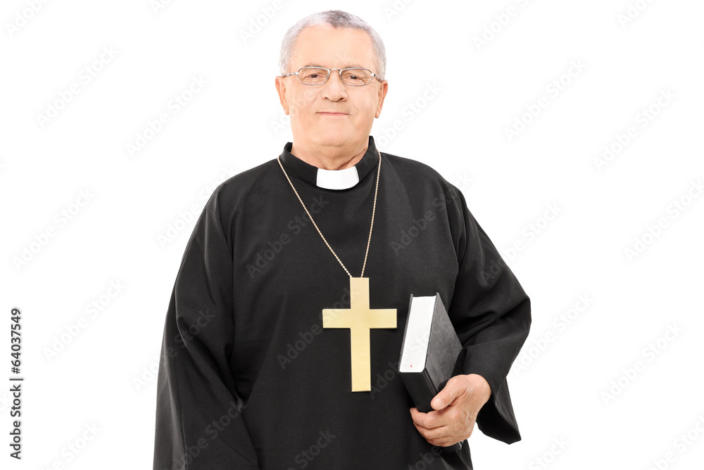 Wall mural mature priest holding a bible