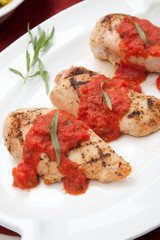 Grilled chicken breast with tomato tarragon sauce.