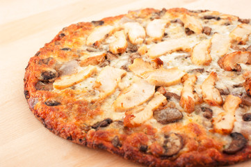 Chicken pizza on wooden cutting board