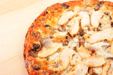 Chicken pizza on wooden cutting board