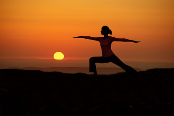 Outdoor sunrise yoga girl