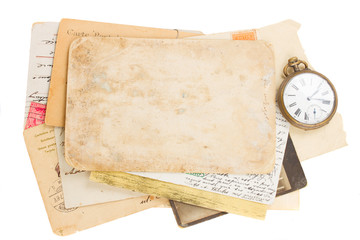 bunch of old photos and papers with antique clock