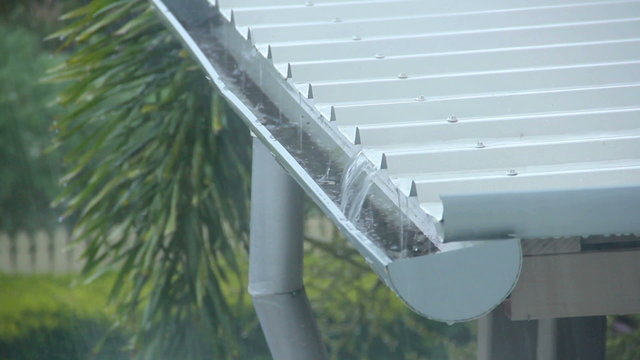 Rain pouring onto a corrugated aluminium roof