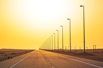 Empty road in the desert at sunset, United Arab Emirates