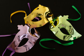 Three carnival masks on dark background