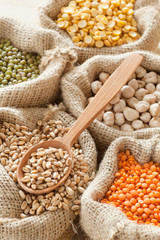 Fototapeta premium hessian bags with wheat, peas, chick peas, red lentils and gree