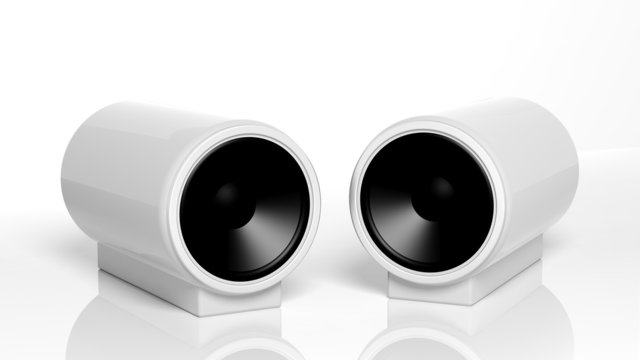Two small white computer speakers isolated on white