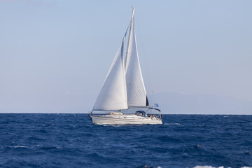 Sailing boat in blue sea