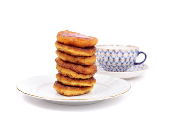Thick pancakes and tea isolated on white